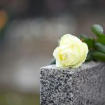 White,Rose,On,Grey,Granite,Tombstone,Outdoors,,Space,For,Text.