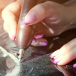 Girl,Engraves,On,Granite